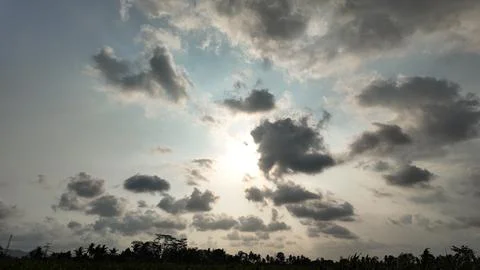 Dramatic dark and bright clouds filling the sky with sunlight Stock Photos