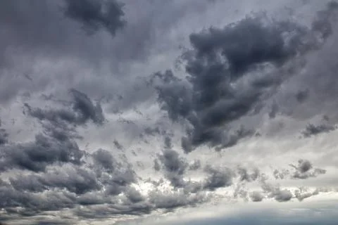 Dramatic dark and ominous storm clouds filling the sky on an overcast day. Stock Photos