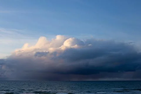 Dramatic dark blue grey yellow stormy cloudy sky and evening winter Baltic se Stock Photos
