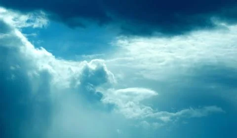 Dramatic dark blue sky with heavy clouds background. Stock Photos