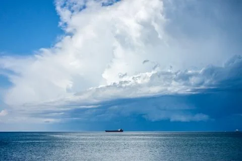 Dramatic dark blue stormy sky over sea surface Foto stock