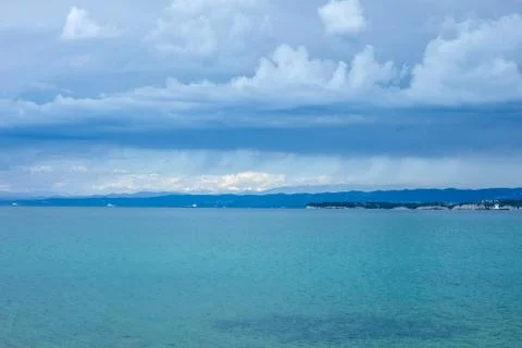 Dramatic dark blue stormy sky over sea surface Stock Photos