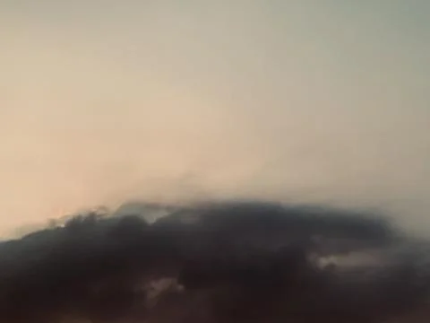 Dramatic Dark Cloud Bank with Warm Atmospheric Light and Open Sky Stock Photos