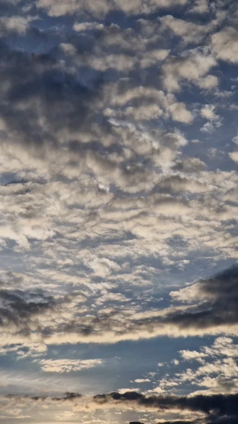 Dramatic dark clouds against the backdrop of an evening backlit sky Vídeos de archivo 344811085