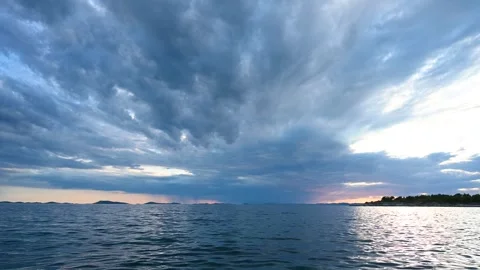Dramatic dark clouds over the sea. Rain clouds at sunset. Stock Footage 248064328