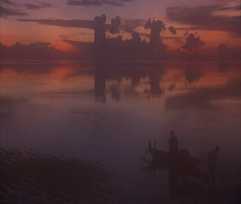 Dramatic dark clouds reflected in purple and orange still water Stock Footage 86747550