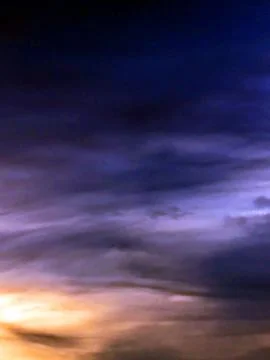 Dramatic Dark Forboading Sunset Clouds Abstract Blues and Yellows in the Sky Stock Photos