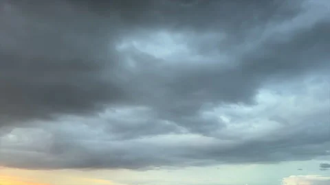 Dramatic dark gray storm clouds rolling across the sky in time lapse creati.. 動画素材 348274074