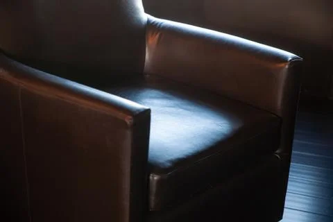 Dramatic dark lighting on comfortable office chair Stock Photos