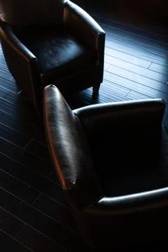 Dramatic dark lighting on comfortable office chair Stock Photos