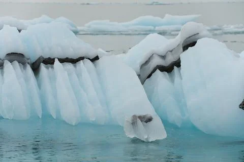 Dramatic dark lines and strata in melting icebergs in Northern Arctic Stock Photos