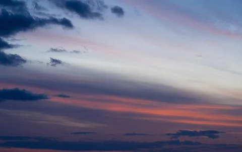 Dramatic dark moody blue and pink sunset sky. Natural background Stock Photos