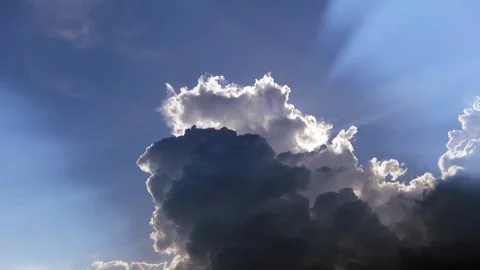 Dramatic dark rain cloud n bright sun light or sunlight ray on blue sky Stock Footage 299778845