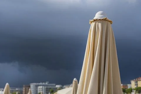 Dramatic dark raining cloud background with Umbrella Stock Photos