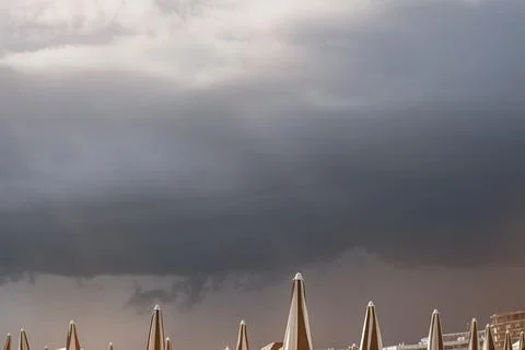 Dramatic dark raining cloud background with Umbrella Stock Photos