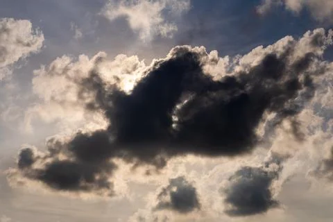 Dramatic dark storm cloud covering the sun in the sky 스톡 사진