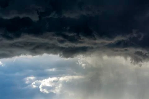 Dramatic dark storm cloud front with rain coming down; Calgary, Alberta, Canada 写真素材