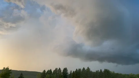 Dramatic Dark Storm Clouds Bubbling Over Forest at Sunset Stock Footage 330800200