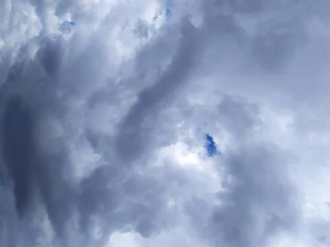 Dramatic dark storm clouds covering the sky. Overcast weather background texture Stock Photos
