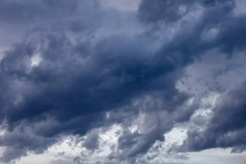 Dramatic dark storm clouds gathering in the sky, hinting at impending weath.. Stock Photos