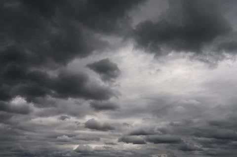 Dramatic dark storm clouds gathering in the sky creating an ominous atmospher 库存照片