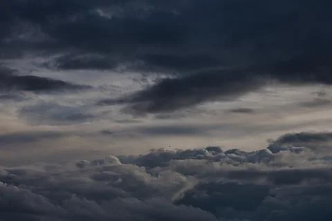 Dramatic dark storm clouds gathering in the sky at dusk Stock Photos