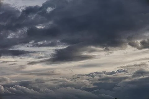 Dramatic dark storm clouds gathering in the sky overhead Stock Photos