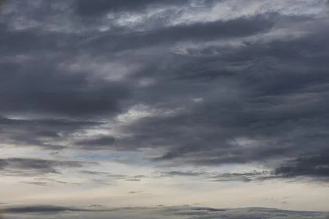 Dramatic dark storm clouds gathering in the sky before a weather change Stock Photos