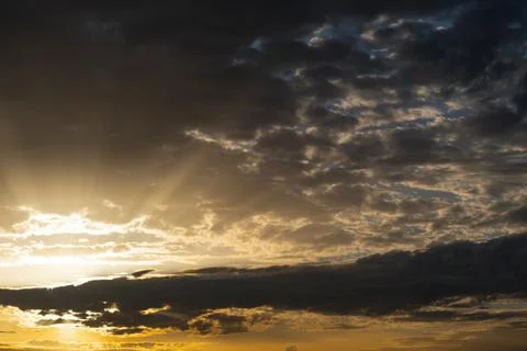 Dramatic Dark Storm Clouds at Golden Sunset Stock Photos