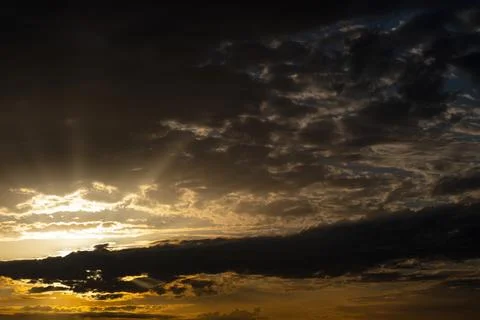 Dramatic Dark Storm Clouds at Golden Sunset Stock Photos