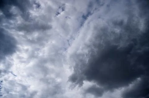 Dramatic dark storm clouds in moody sky Stock Photos
