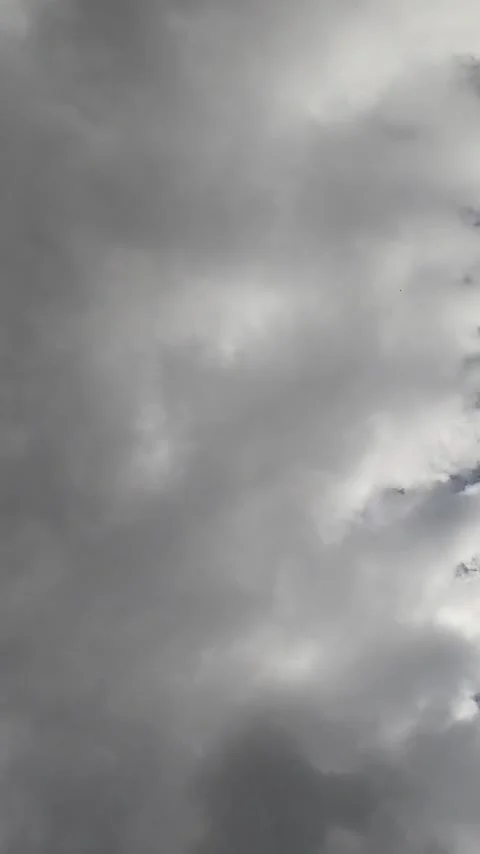 Dramatic dark storm clouds moving and transforming across the bright blue sky Stock Footage 346606385