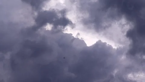 Dramatic dark storm clouds with sunlight breaking through before monsoon rain Stock Footage 336532859
