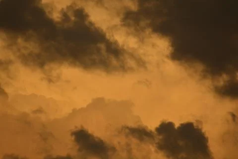 Dramatic Dark Storm Clouds at Sunset Glow Stock Photos