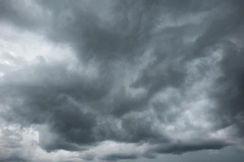 A dramatic dark storm cloudy sky or cloudscape.  Wide-angle view, gray clouds Stock Photos