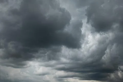 A dramatic dark storm cloudy sky or cloudscape.  Wide-angle view, gray clouds Stock Photos