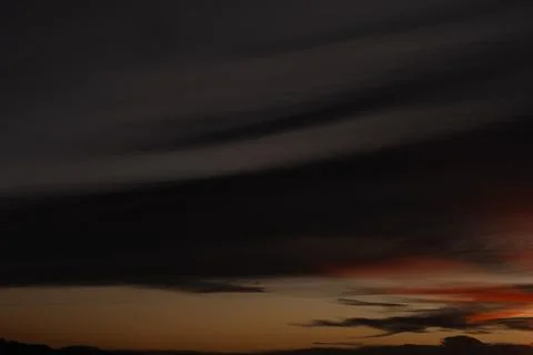 Dramatic Dark Sunset Sky With Wispy Clouds Stock Photos
