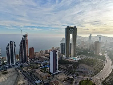 Dramatic dawn illuminates coastal structures with golden rays piercing morning Stock Photos