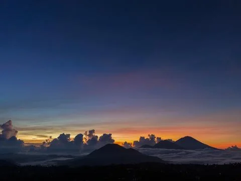 Dramatic Dawn Sky Over Volcanic Peaks and Thick Sea of Clouds 写真素材