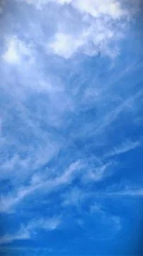 Dramatic Deep Blue Sky with Scattered White Wispy Clouds Stock Photos