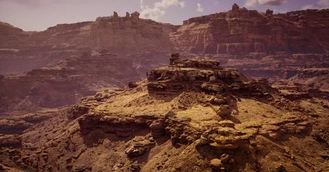 Dramatic desert canyon at sunset with rugged rock formations Illustrazione stock
