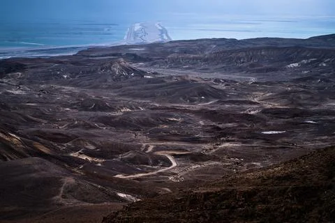 Dramatic desert coastline landscape with storm clouds over calm sea Photos