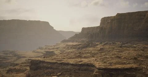 Dramatic desert landscape with rocky cliffs and soft sunlight in the afternoo Illustrazione stock