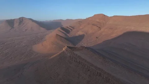 Dramatic Desert Mountain Ridges with Long Shadows at Golden Hour Stock Footage 336025352