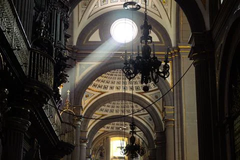 Dramatic divine sunbeam piercing through dome illuminating ornate interior of Ca 스톡 사진