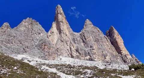 Dramatic Dolomite Mountain Spires Under Blue Sky Stock Photos