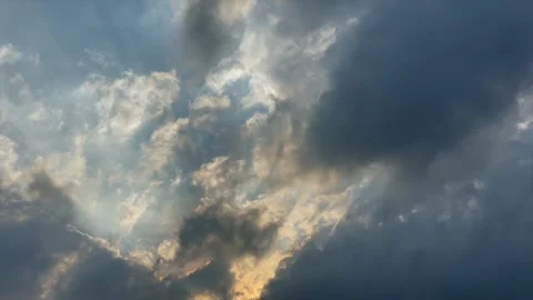 Dramatic dramatic sky with sun rays breaking through dark storm clouds Stock Footage 341894442