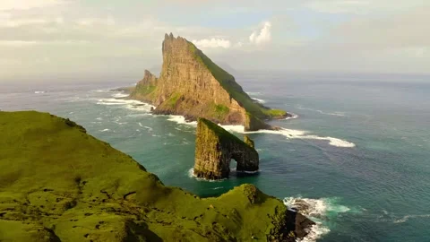Dramatic drangarnir sea stacks standing in ocean waters near green cliffs faroe Stock Footage 343696461