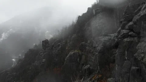 Dramatic drone flying between rocks in a rainy day Stock Footage 259964374