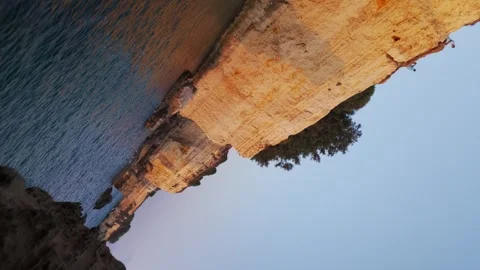 Dramatic drone movement pass along the golden limestone cliffs of Torre Stock Footage 318516118